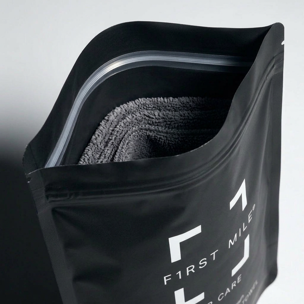 F1rstmile resealable bag opened showing grey microfiber towel inside